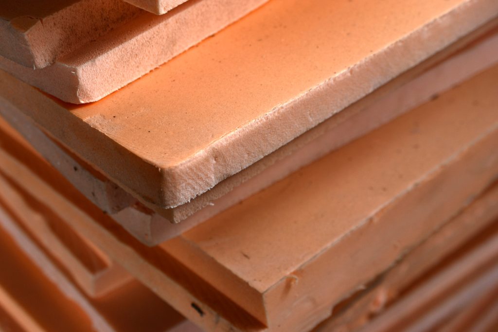 Plates of pink-colored porous insulation material