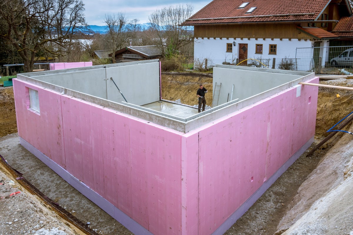 Prefabricated house, workers in setting up the basement walls