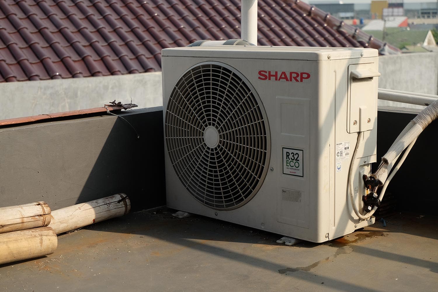 Sharp air conditioner box outside that is placed on top of the house