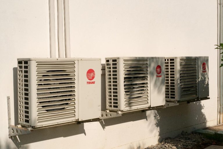 A TRANE condensing units of air conditioner at a white painted wall, What MERV Rating Does Trane Recommend?