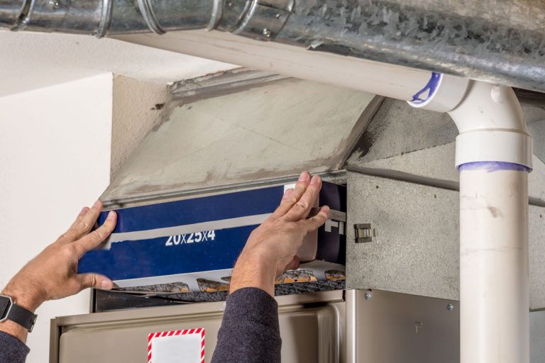 Technician changing the furnace air filter with a new one, Furnace Filter Vs Return Air Filter: Which To Choose?