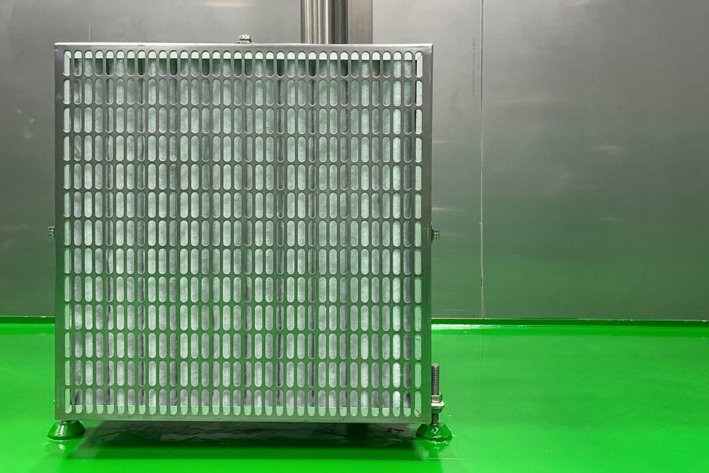 The air filter unit, which is covered with an aluminum mesh, is placed on the green epoxy floor in the clean room to filter the exhaust air in the room.