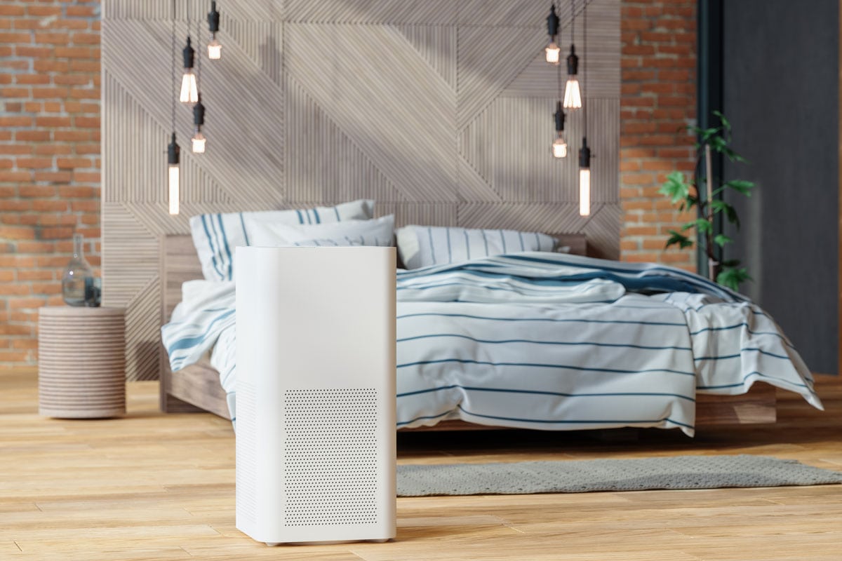 White air purifier inside minimalist bedroom