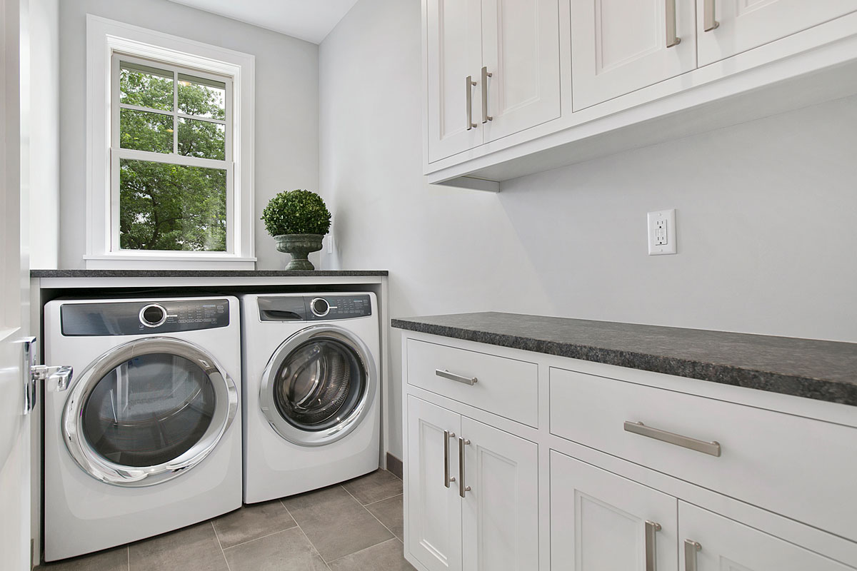 White laundry room with new appliances