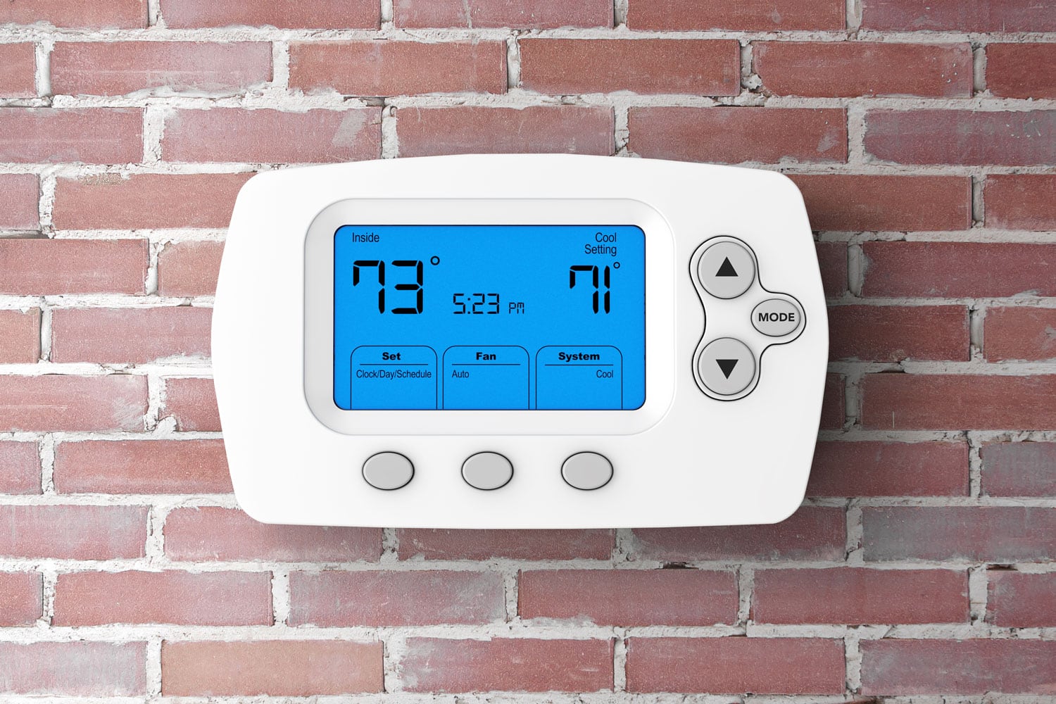 White thermostat mounted on a brick wall