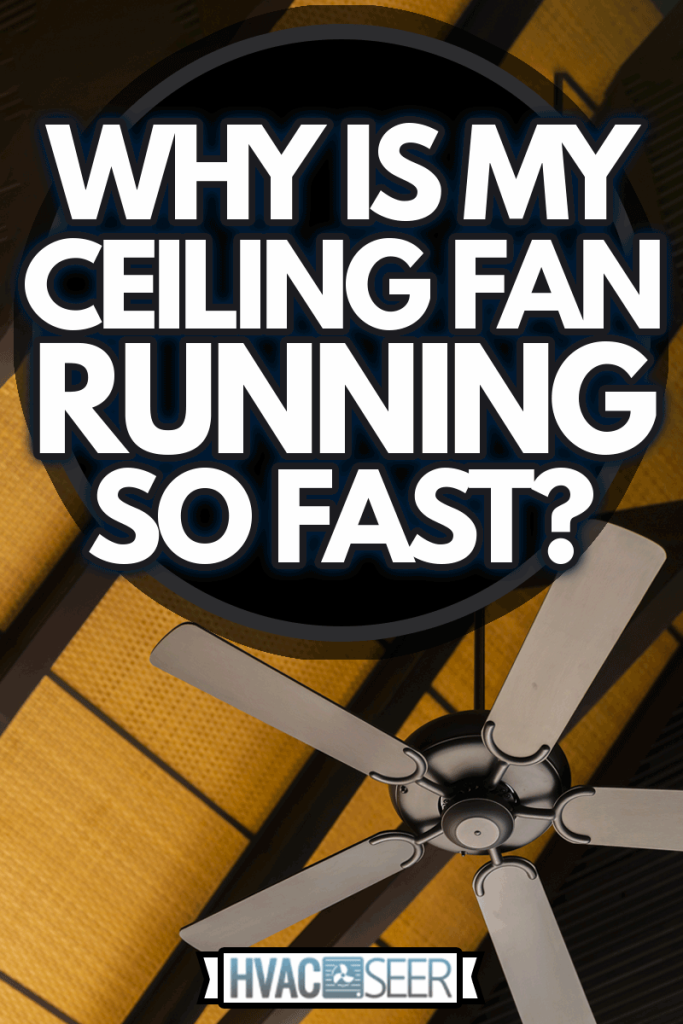 Brown indoor ceiling fan on an exposed wooden support beam, with a decorate wooden ceiling, in the hall of living room of a contemporary home interior, Why Is My Ceiling Fan Running So Fast?
