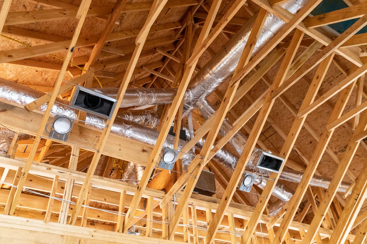 Wooden framing or the roofing with visible ductwork for heating and air conditioning