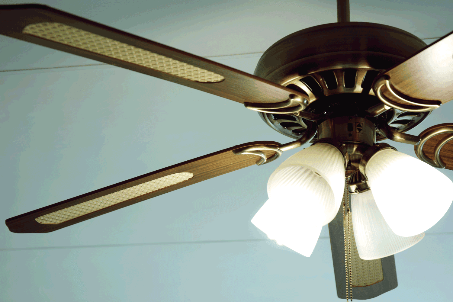 retro style ceiling fan with wooden blades and lighted centerpiece
