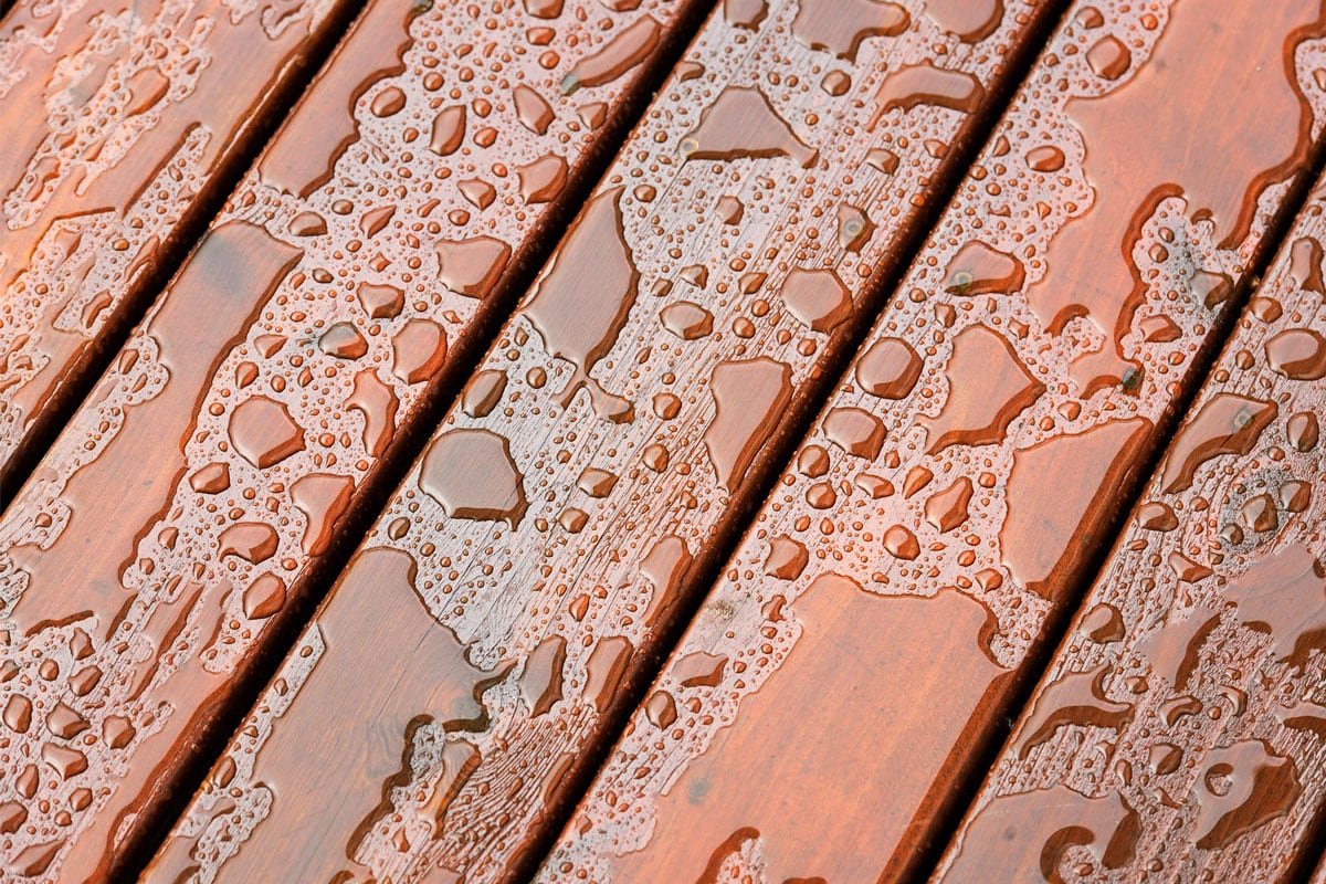 wet surface of protected wooden decking following heavy rain