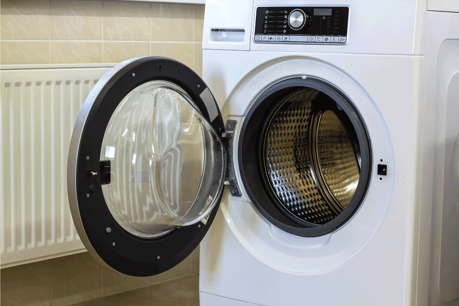 A close up of open washing machine in bathroom