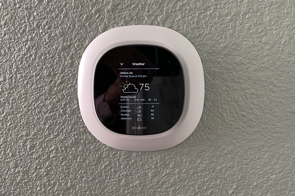 A thermostat installed in a wall called smart ecobee