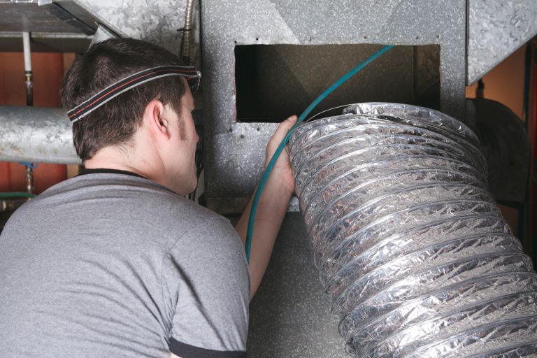 A man installing flexible ductwork, How Long Does Flexible Ductwork Last?