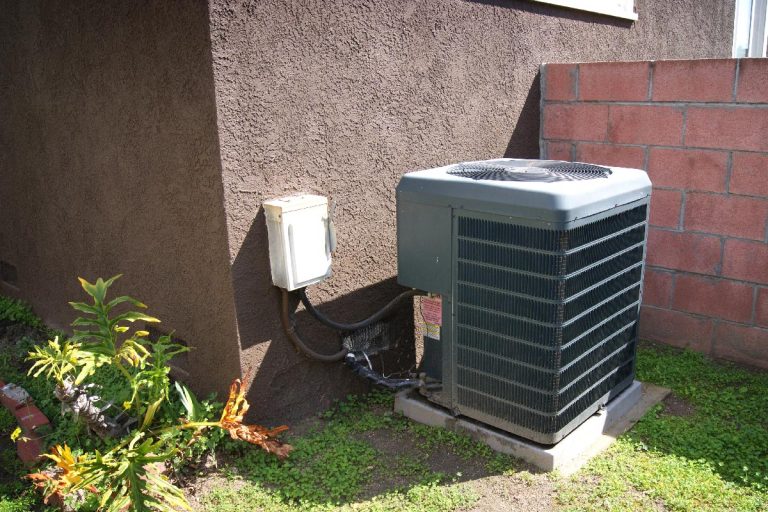An air conditioner outside of house, How To Reset Your Outside Air Conditioning Unit