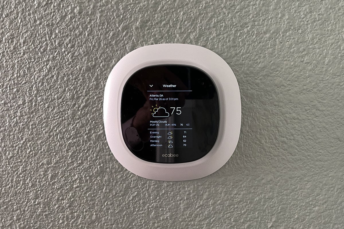An Ecobee thermostat mounted in the living room wall