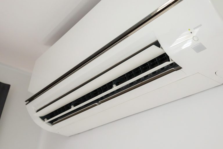 An air conditioning unit mounted on a white wall, Mr. Cool Follow Me Not Working - Why And What To Do?