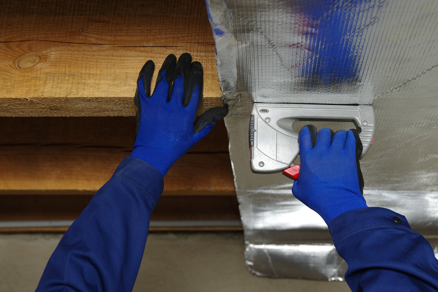 Builder attaches vapor barrier membrane to protect the mineral insulation