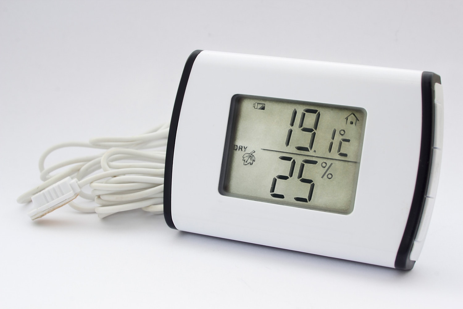 Close view of electronic thermometer hygrometer in a white background