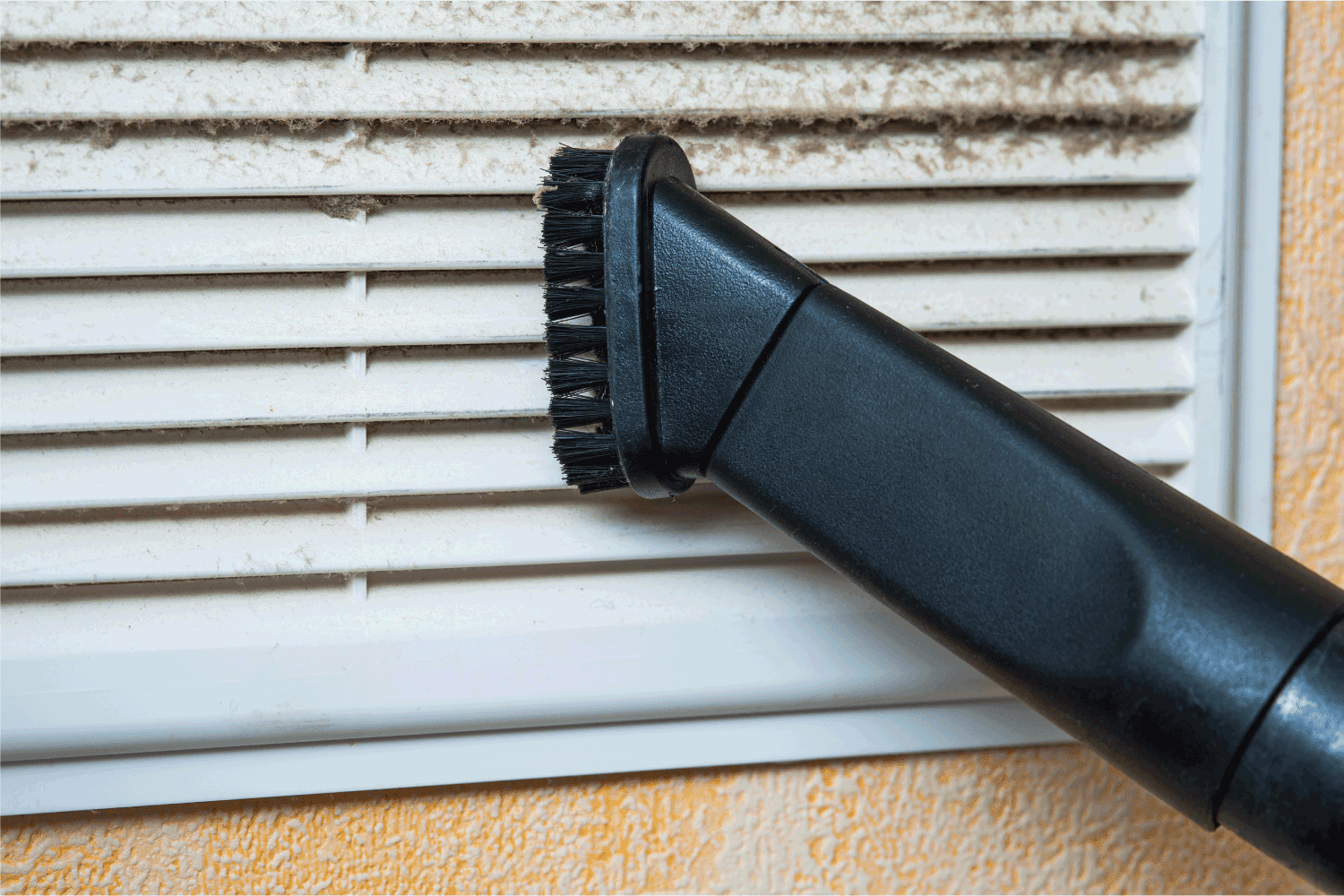 Closeup of vacuum cleaner pipe and ventilation grill