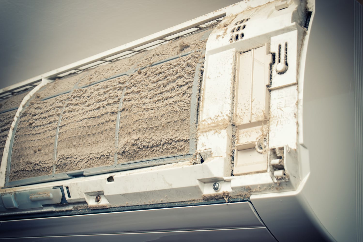 Closeup view of an open Air condition unit and very dirty air filters.