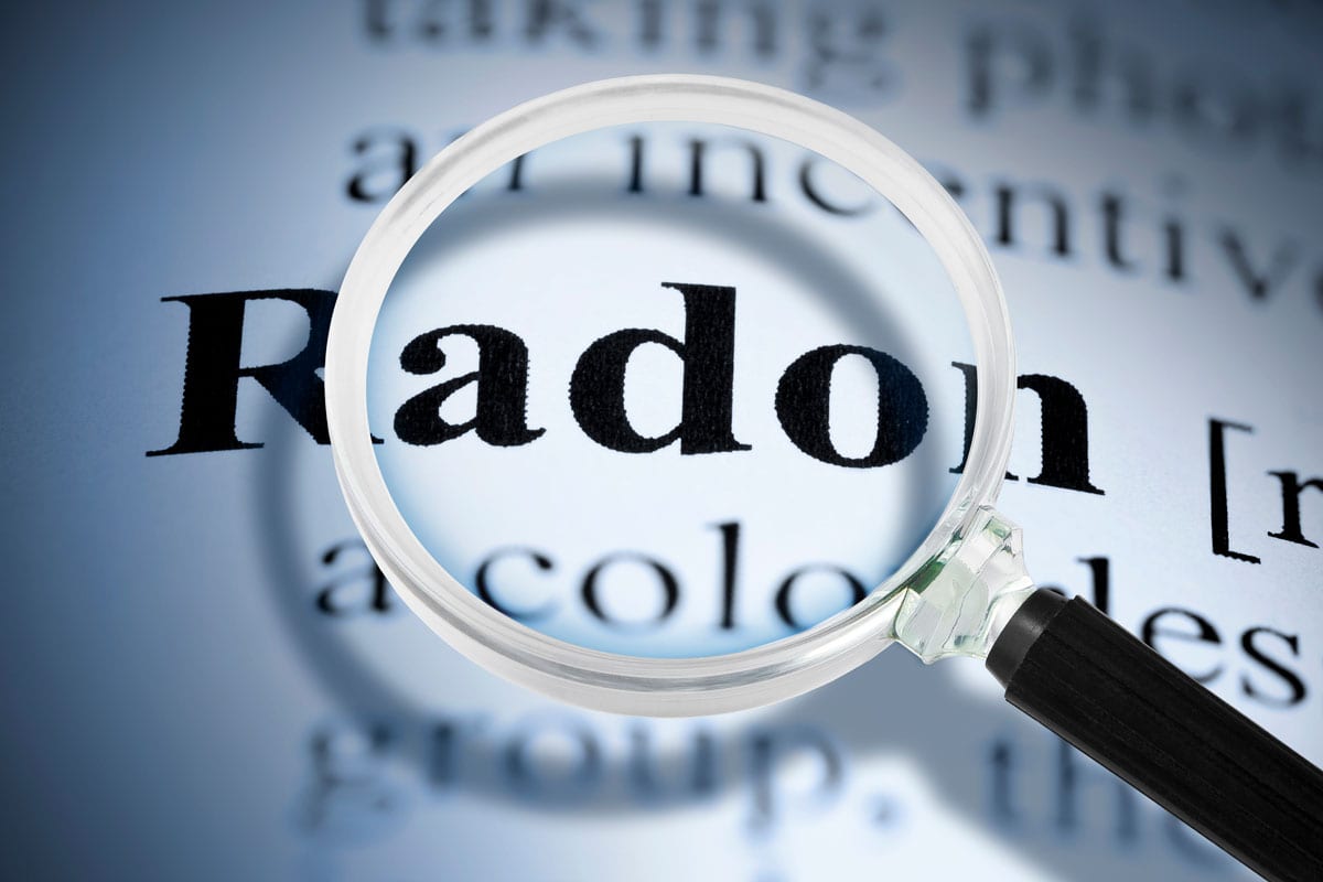 Dangerous radon gas text seen through a magnifying glass