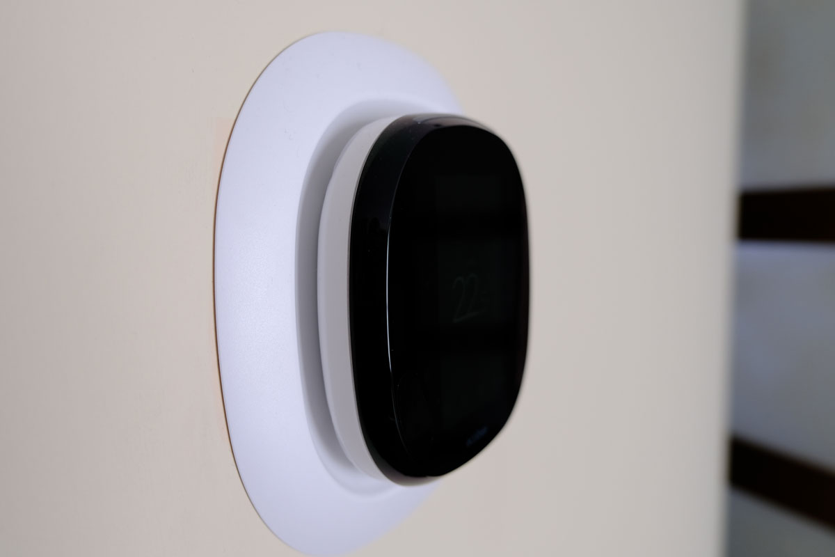 Energy-saving thermostat for temperature control. Modern design, ecobee style installed on the wall