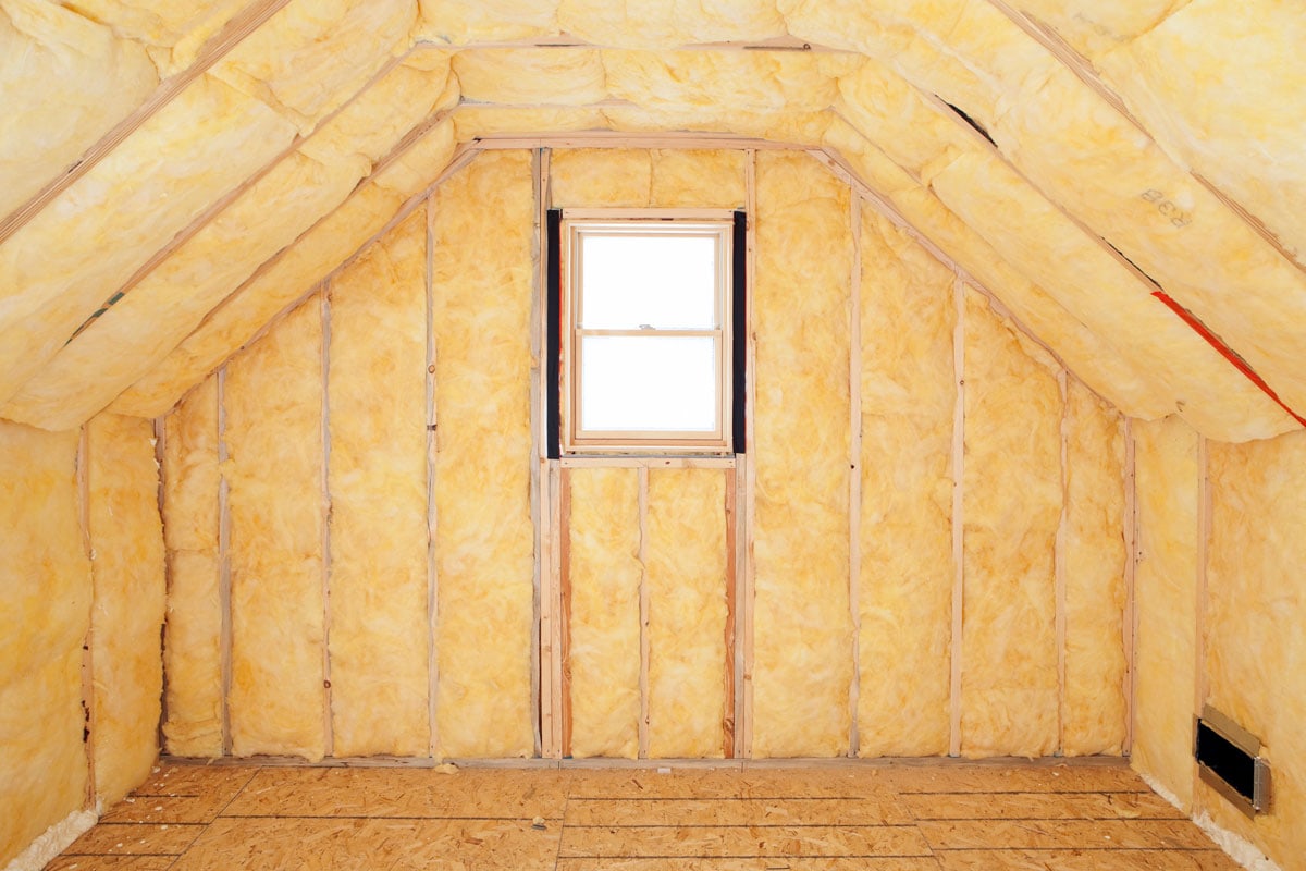 Fiberglass insulation on the walls inside an attic