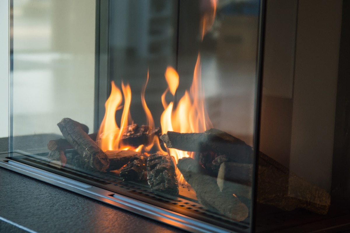 Fire burns in a glass fireplace