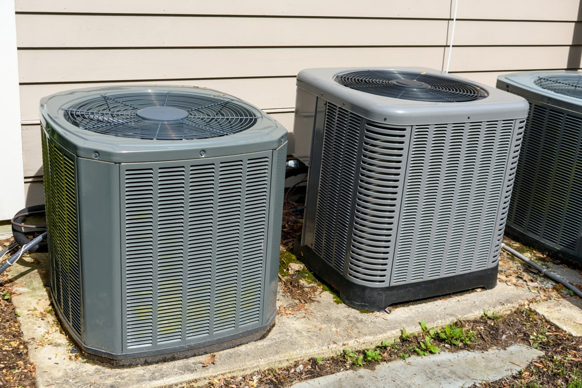 Gray Bryant air conditioning units mounted on concrete pads