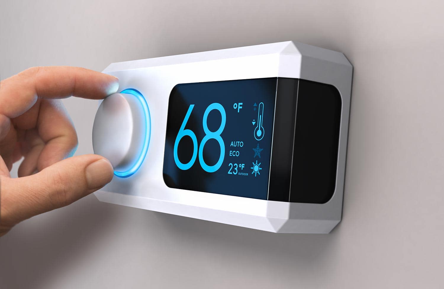 Hand turning a home thermostat knob to set temperature on energy saving mode