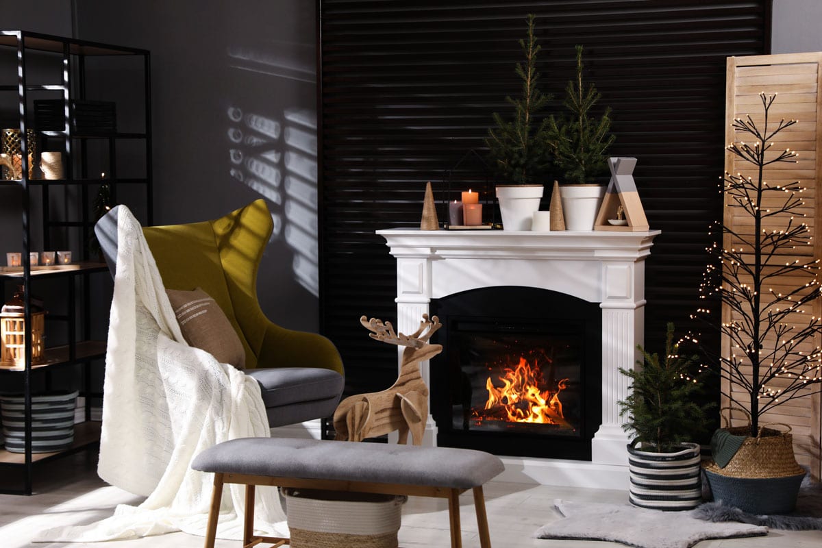 Interior of a modern house with a white mantel fireplace and a gorgeous gray and yellow accent chair