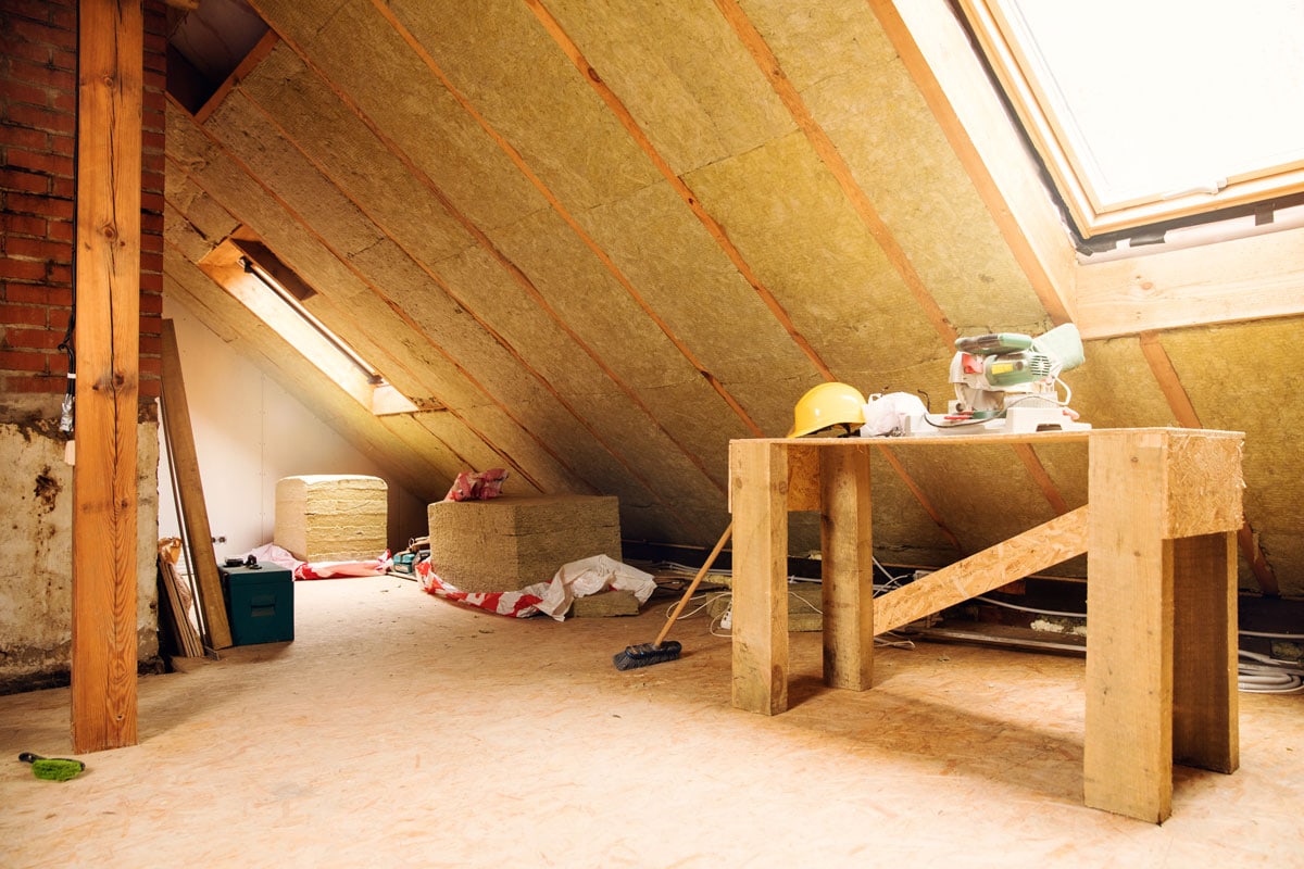 Interior of an attic with mineral insulation and other construction equipment's