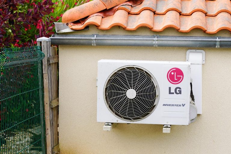 An LG smart inverter mounted on home wall of house. How Long Do LG Air Conditioners Last?