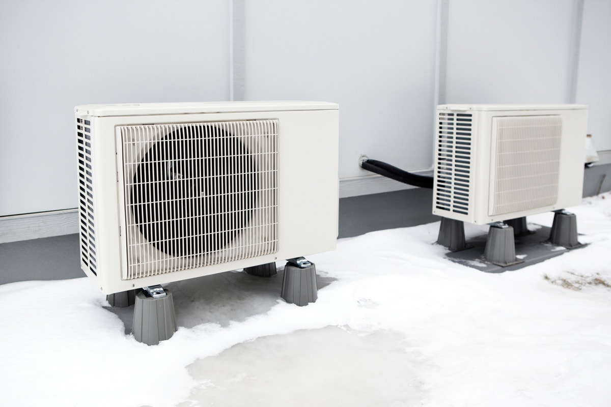 Mini-split heating and air conditioning system outdoor condenser units. A modern heat pump, this unit heats a house in winter and cools in the summer. 