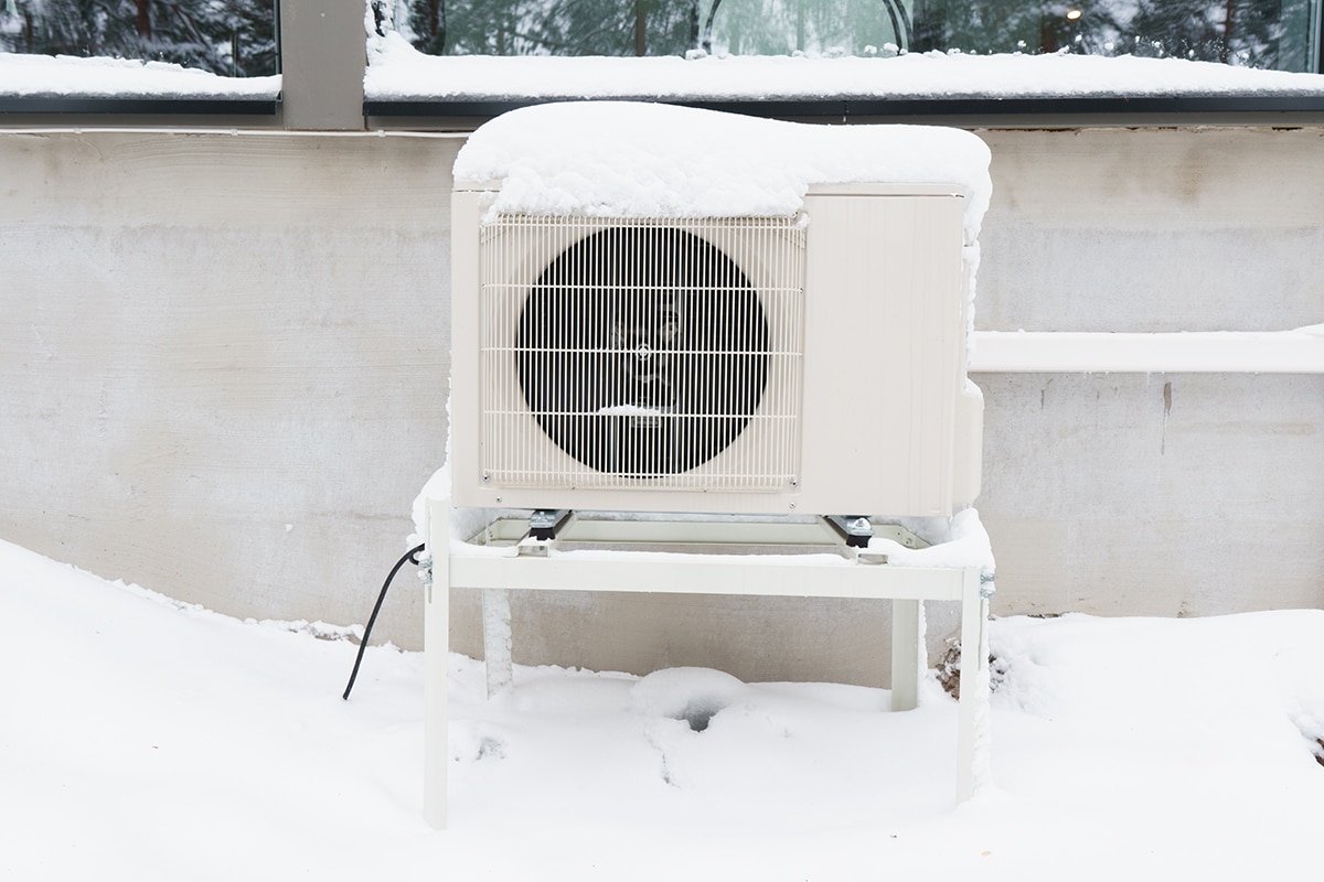 Outdoor unit of an air-source heat pump after a winter storm