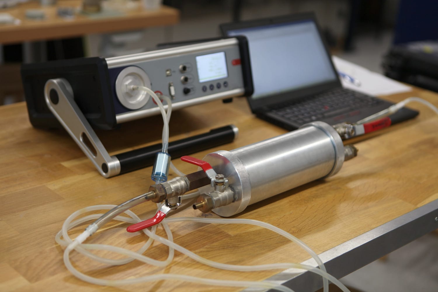Radon gas radiation detectors testing. Dosimetrist holding a portable gamma radiation dosimeter set on a long tube with sample probe