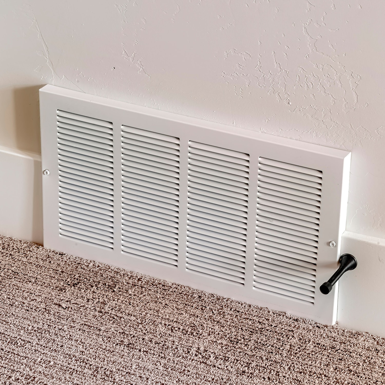 Square air conditioner white plastic grille cover against wall and carpet floor