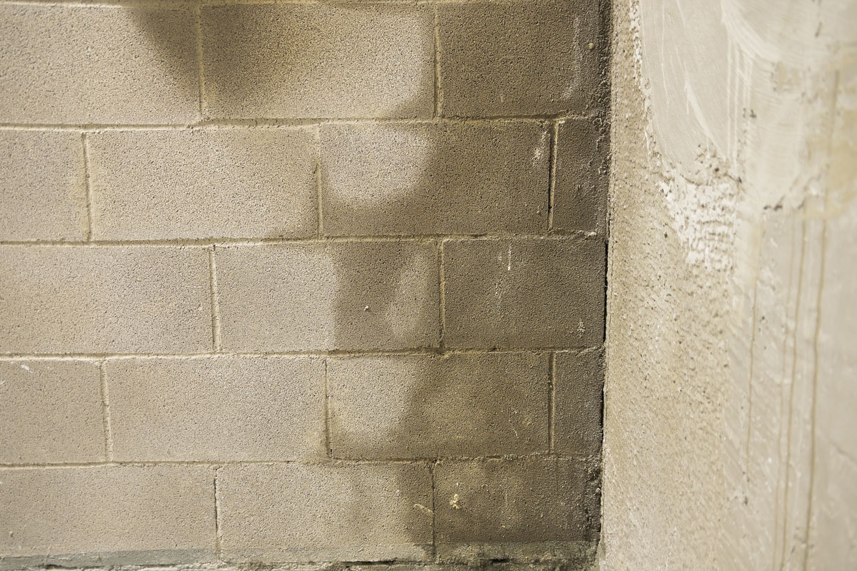 Wet cinder blocks due to high moisture content of the room