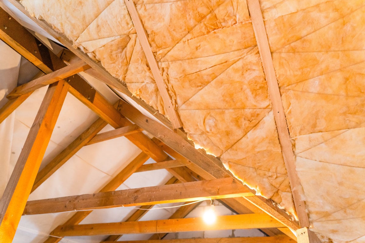 Wooden framing of a house with wool insulation and vapor barrier