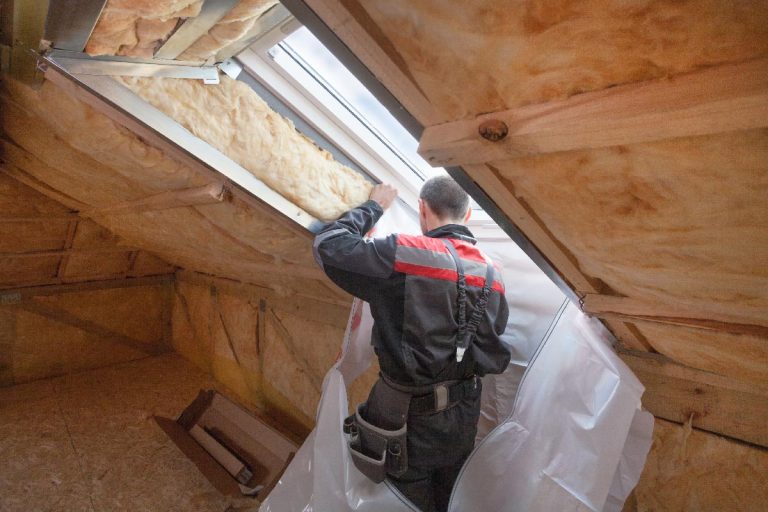 A worker installing vapor barrier around the skylight opening in attic, Double Vapor Barrier: Pros, Cons And Problems