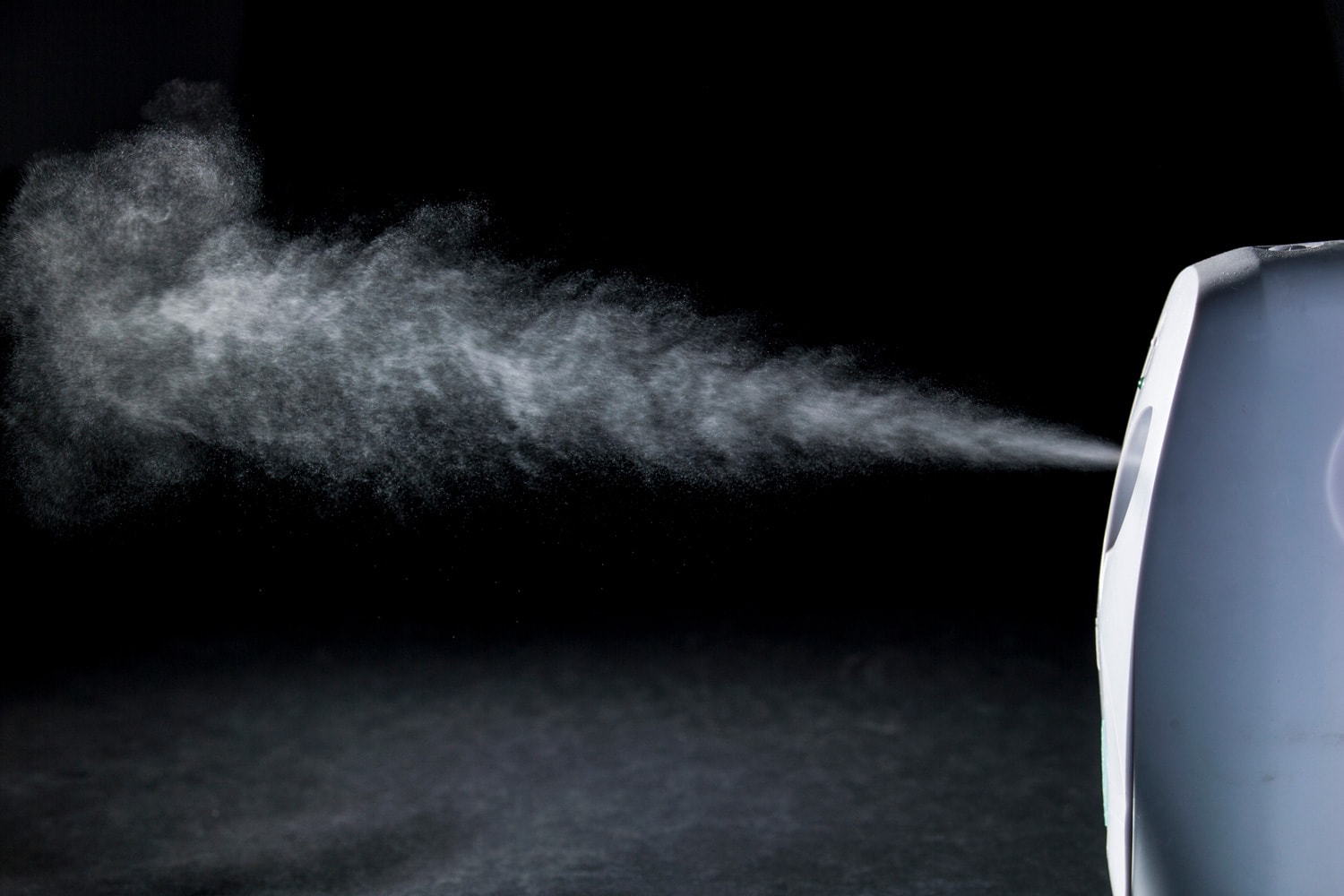 air freshener spray in front of black background