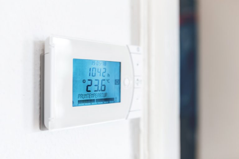 climate control panel on the wall in a room in a residential building. HVAC and electronic smart house concept - Thermostat Not Shutting Off When Reaching The Temperature - What To Do
