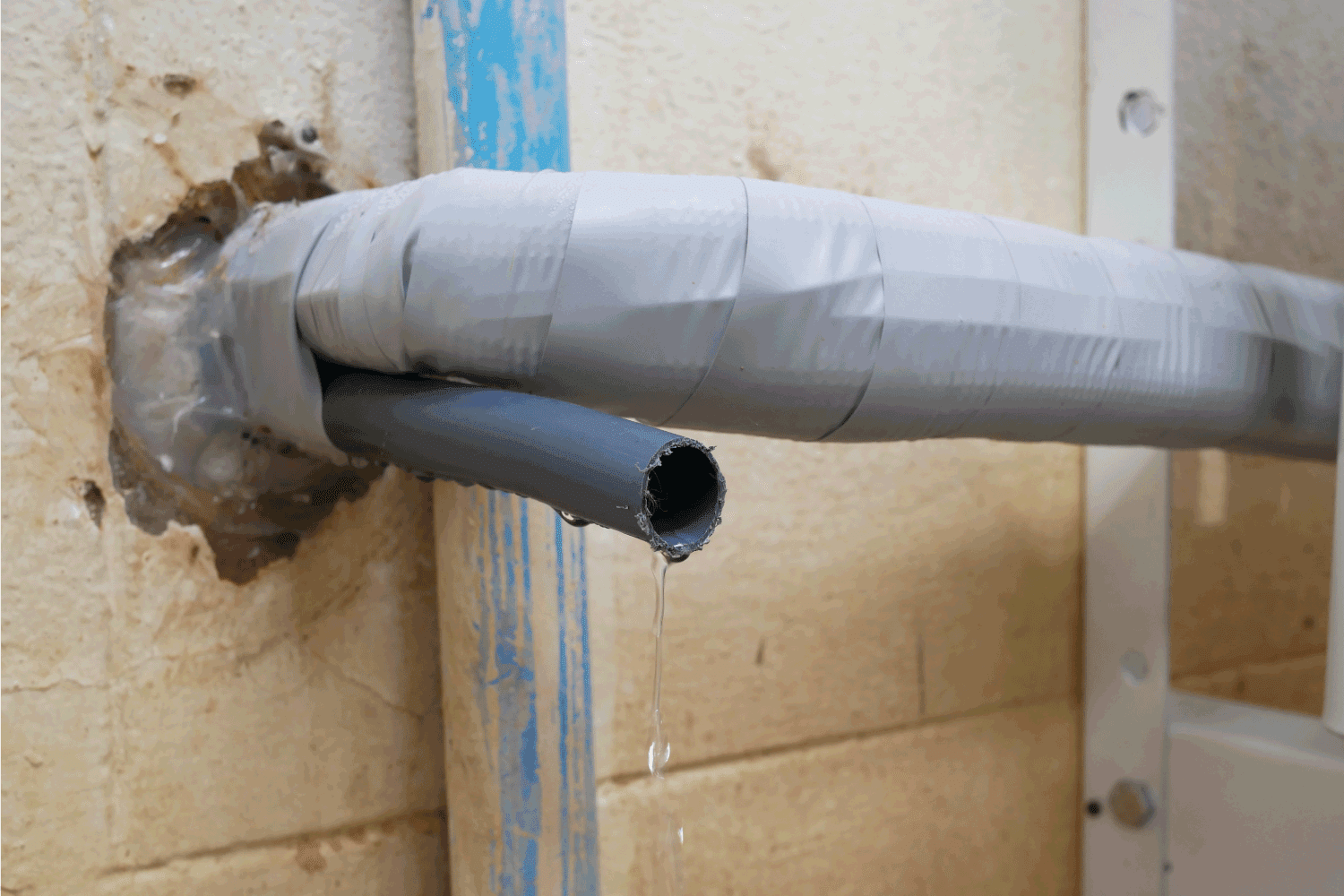 plastic drain pipe from air conditioning outside building.