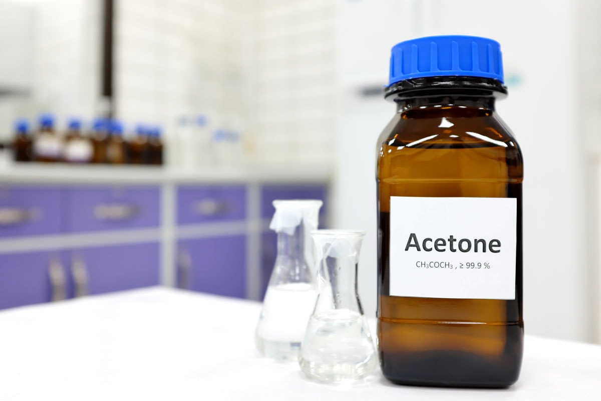 pure acetone solution in brown glass amber bottle inside a chemistry laboratory