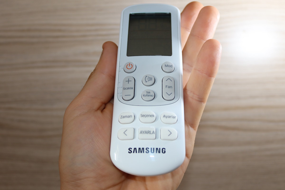 samsung air conditioner remote in a man's hand