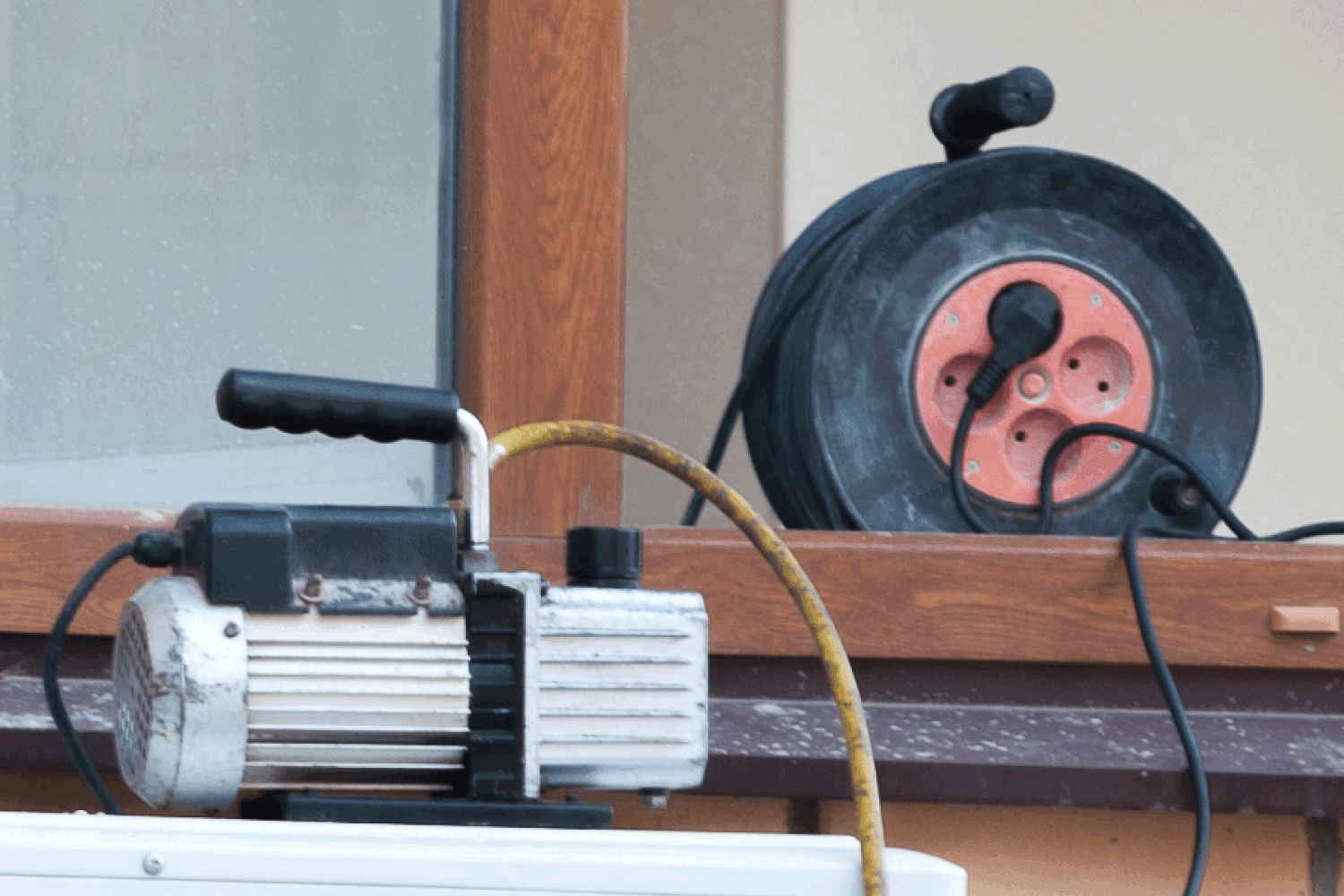 vacuum pump and extension wires on a window