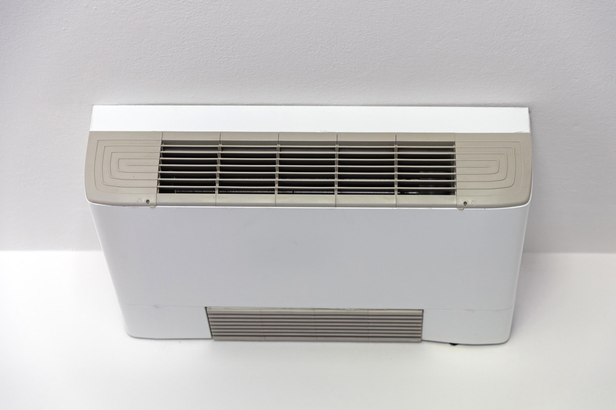 A PTAC air conditioner on the living room floor