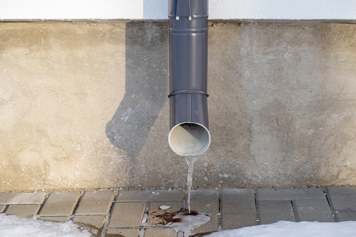 A gray painted exterior drain pipe