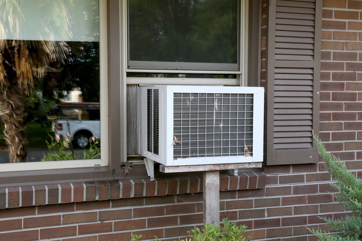 A old window unit air conditioner still being used by people whom don't have central air.
