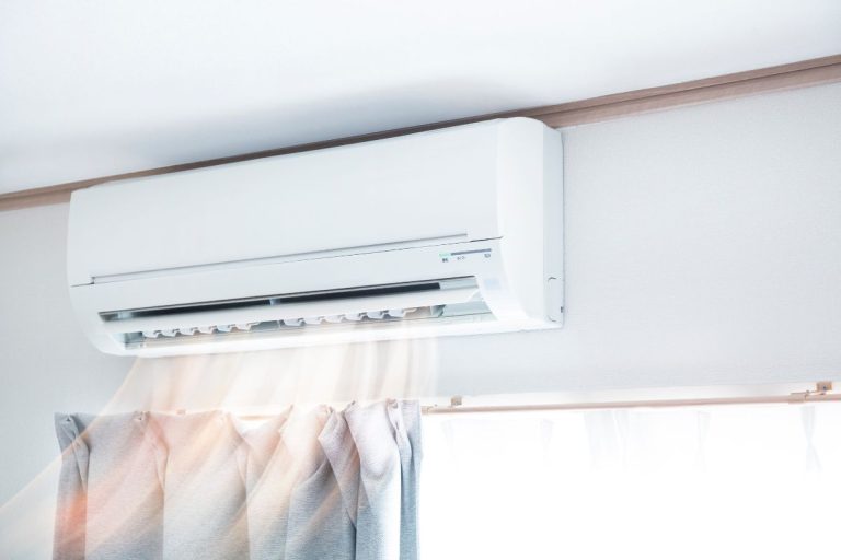 Air conditioner blowing warm air