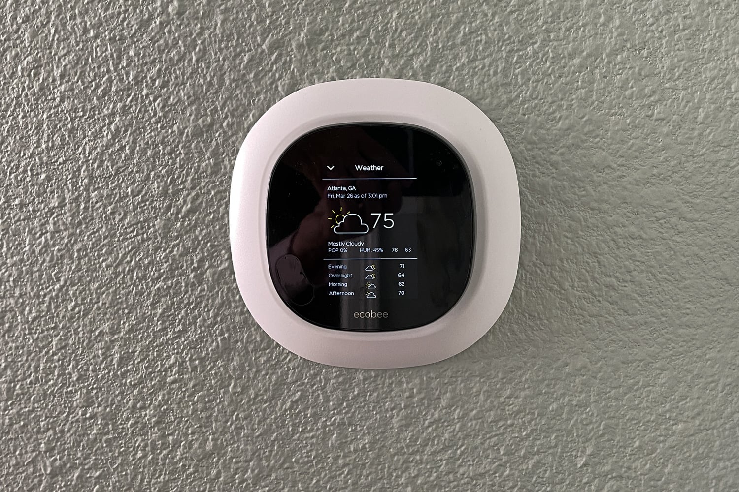 An Ecobee smart thermostat in a home